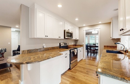 Union House | Remodeled home with game room, modern amenities, & golf course views