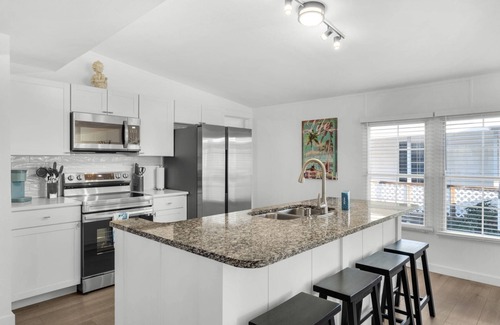 Bayside Park House | Renovated canal-front pet-friendly home with a fireplace and boat dock, steps away from the marina!