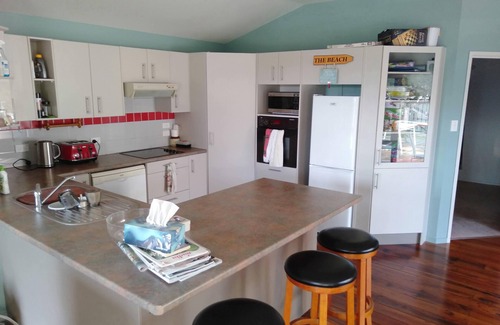 Waitarere Beach House | Renovated oasis with large deck and leafy privacy