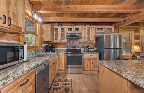 Sevierville Cabin | River-View Home w/Multi-Level Deck, Yard, Hot Tub, & Free Attraction Tickets