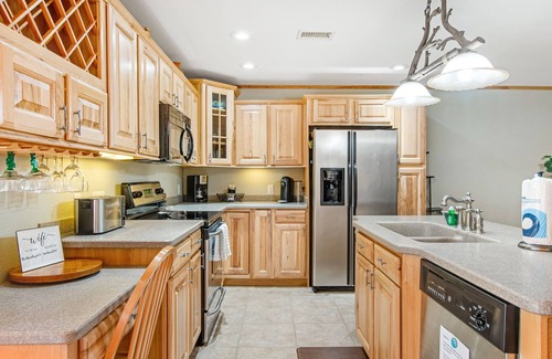 Arkdale Condo | Riverfront golf resort condo with pool, hot tub, volleyball, & fairway-view deck
