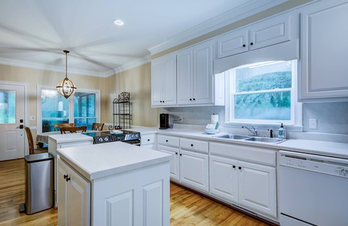 Wiley House | Riverfront hideaway with grill, game room, home theater, screened porch, & deck
