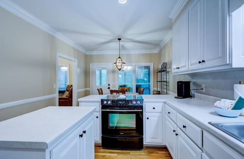 Wiley House | Riverfront hideaway with grill, game room, home theater, screened porch, & deck