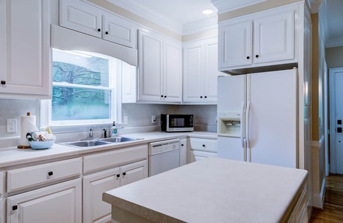Wiley House | Riverfront hideaway with grill, game room, home theater, screened porch, & deck