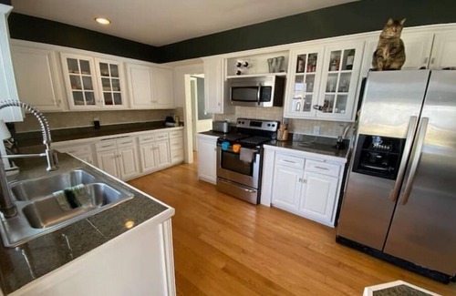 Menasha House | Riverfront Oasis - Hot tub- Seasonal heated pool