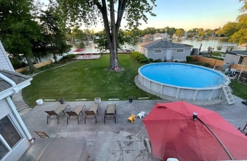 Menasha House | Riverfront Oasis - Hot tub- Seasonal heated pool