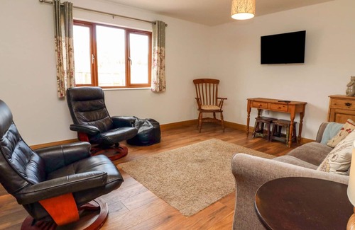 Old Cleeve Cottage | RIVERSIDE LODGE, pet friendly, with a garden in Washford