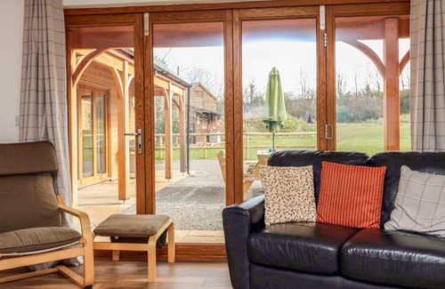 Old Cleeve Cottage | RIVERSIDE LODGE, pet friendly, with a garden in Washford