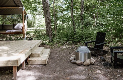 North Woodstock RV Rental | Safari Tent Site 12 | 1 King Bed | Woods View