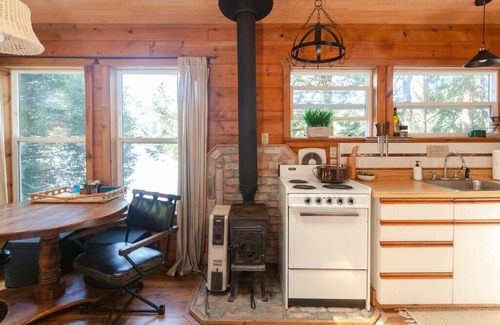Lakeside Cabin | Secluded 1-bedroom lakefront cabin in Lakeside, OR. Ideal for writers or couples seeking solitude. Features a King bed, wood stove, kayak for 2, and stargazing from your private dock.