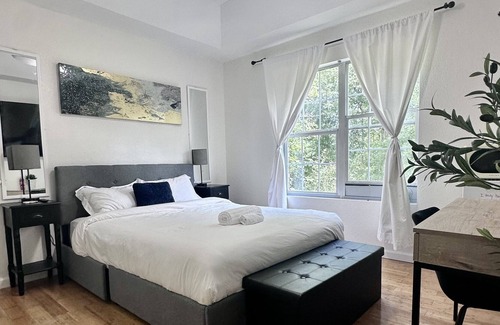 Fortson House | Serene room haven with private fridge, microwave, and 60” smart TV with Netflix.