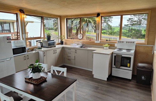 Awhitu Apartment | Sky tower and Water view over looking Paddock