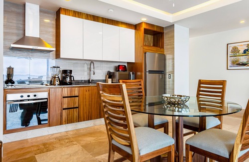 Mismaloya Condo | Sleek 9th-floor condo with wraparound balcony, ocean views & pool