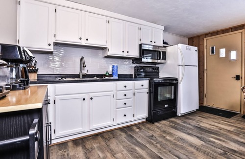 St Germain Cabin | Snowy lake-view cabin with fireplace, full kitchen, TV, dock, & DVD player