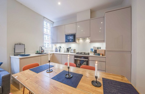 Shoreditch Apartment | Spacious first-floor apartment with lift access on Great Titchfield Street. Sleeps 18 with 3 bedrooms, 3 living rooms, 3 kitchens, and 3 bathrooms. Steps from Oxford Street and Soho.