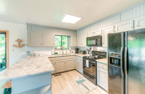Bumpass House | Spacious lakeside home featuring a private cove, hot tub, dock & theater room