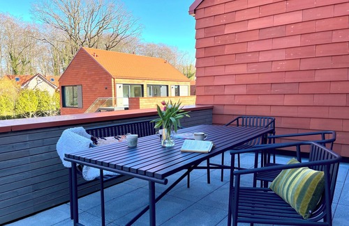 Hohwacht Apartment | Spacious, light-filled loft with rooftop terrace and fireplace.