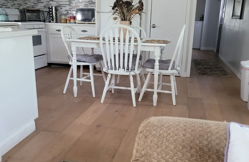 Kiteley House | Spacious mobile home with large kitchen/living area and porch with barbeque.