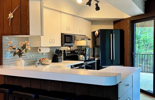 Michaywe House | Step into Time Capsule Tower, a retro 70s escape with 5 themed bedrooms, movie room, hot tub, sauna, arcade & more. Centrally located near Northern Michigan golf, lakes, skiing, & off-road and snowmobile trails with access to a community pool.