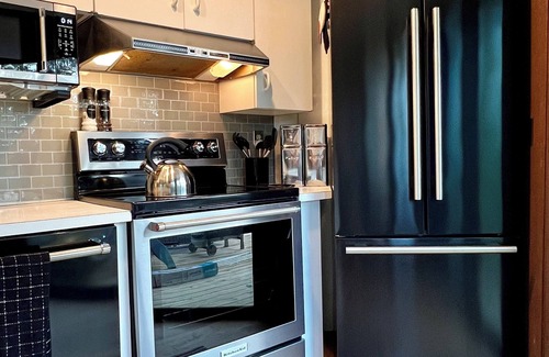 Michaywe House | Step into Time Capsule Tower, a retro 70s escape with 5 themed bedrooms, movie room, hot tub, sauna, arcade & more. Centrally located near Northern Michigan golf, lakes, skiing, & off-road and snowmobile trails with access to a community pool.