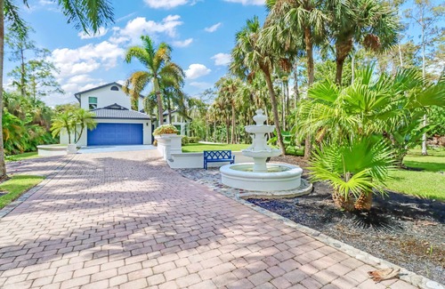 Rural Estates House | Stunning Naples home on 2 acres surrounded by beautiful palm trees and pool!