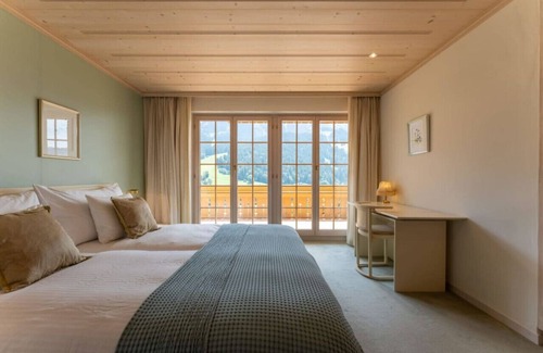 Rougemont Apartment | Stylish Alps apartment near Rougemont Village with mountain views.