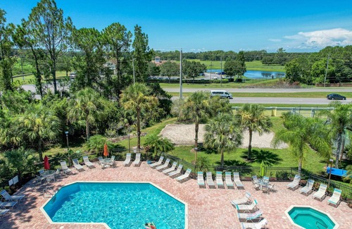 Royal Palm Bay Condo | Sunflower-yellow condo with pool, W/D, hot tub & kitchen - dog/snowbird-friendly