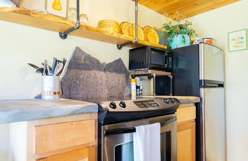 Wildwood Cottage | The Cavern on The Green. A unique hand-carved home. Quiet, great views