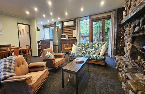 Whiritoa House | The Iconic Log Cabin By the Sea- Pets welcome! Spa! Pool Table/Ping Pong!