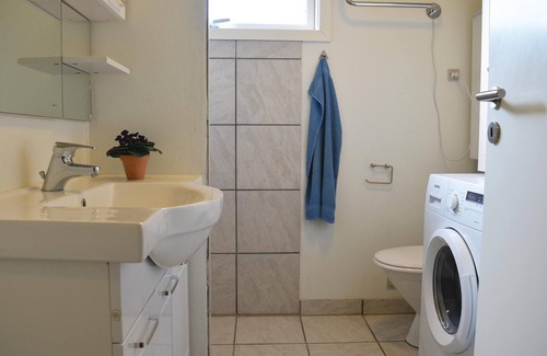 Skovgaarde House | This cozy cottage is family friendly furnished with kitchen and living room with fireplace in open c