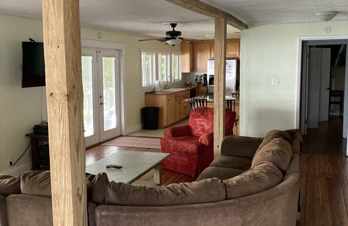 Fairhope Cottage | This inviting outdoor living space is an extension of the home,