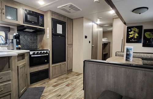 Mill Spring House | Travel trailer near the creek, short walk to pool and playground, indoor and outdoor kitchenette, sleeps 8.