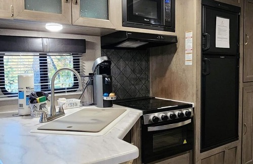Mill Spring House | Travel trailer near the creek, short walk to pool and playground, indoor and outdoor kitchenette, sleeps 8.