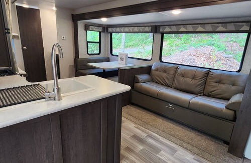 Mill Spring House | Travel trailer near the creek, short walk to pool and playground, sleeps 8.