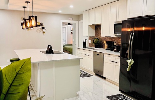 West Palm Beach Villa | Tropical Luxury Retreat with warm Pool, 5-bedroom & Mini Golf, Impact Windows