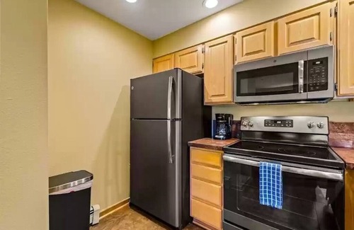 Peak 8 Condo | True Ski-in Ski-Out at Snowflake Chair Lift with Hot Tubs and Fireplace 715 sqft