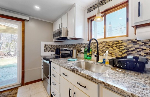 Sandown House | Two-story dog-friendly home with a lake view, deck, gas grill