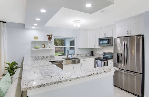 Beau Rivage West House | Updated Stuart home in waterfront community with private backyard, pool & lanai