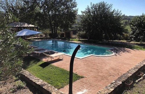 Todi Villa | Villa Gramigna: A charming two-story villa surrounded by the greenery.