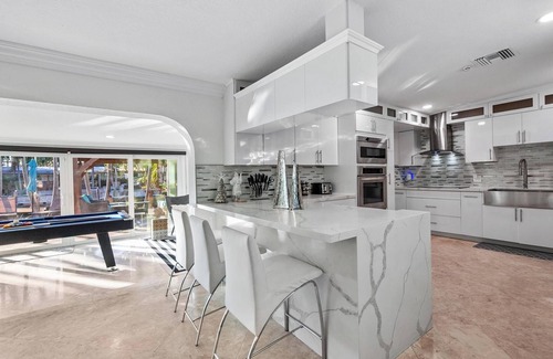 Sunset House | Villa Les Palmieres, a lush waterfront residence with pool and dock