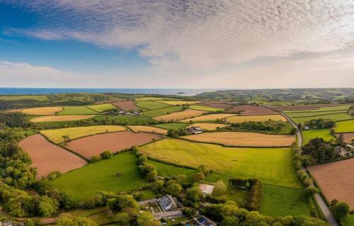 Widegates House | Water Mill at East Trenean Farm -Luxury Cornish Cottage sleeping 4 with hot tub, private garden, rural views and EV facilities