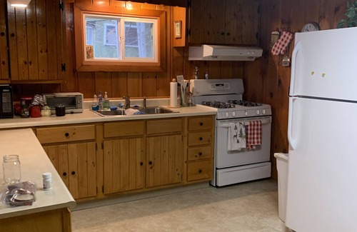 Old Forge House | Waterfront Camp with Boathouse - Wifi, kayaks, canoe and sandy bottom out front.
