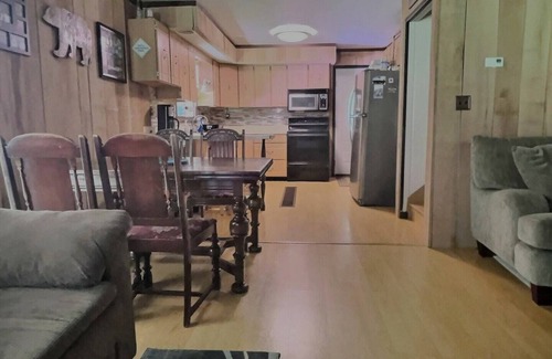 Brookville House | Welcome to your perfect getaway! Nestled on a semi-secluded 2-acre lot, this charming brick Cape Cod is centrally located between Cook Forest and Clear Creek State Parks. Surrounded by trees, this cozy retreat offers a peaceful escape.