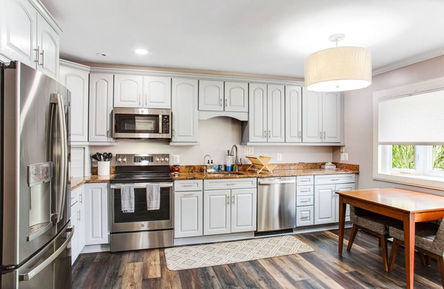2-story, riverfront home with private dock, inviting deck & dog-friendly yard