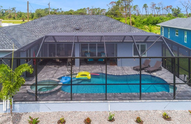ALL the amenities! New home with hot tub, on canal, dock, everything you need!