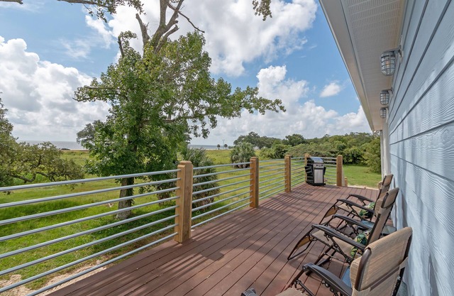 Beach house with gorgeous views, private green space, and steps to the beach.