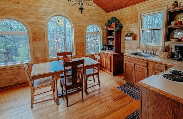 Beautiful, authentic log cabin with acres of land, fishing pond, and hot tub.