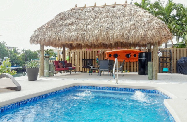 Canal Front Pool Home with Dockage, Jetted Pool, Tiki Hut, 2 Kayaks & 2 Bikes!