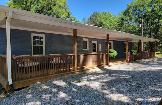 Charming brick home set in the woods on 45 acres with pond and trails.
