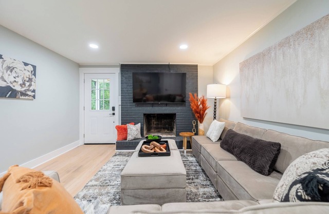 Charming cottage entrance with cozy curb appeal, nestled in a peaceful and green setting.